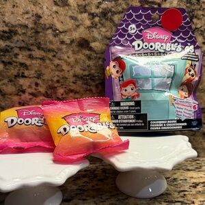 Two Technicolor and one series  Disney Doorables Mystery Packs